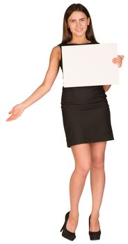 Businesswoman in dress holding white blank sheet of paper and shows his hand aside