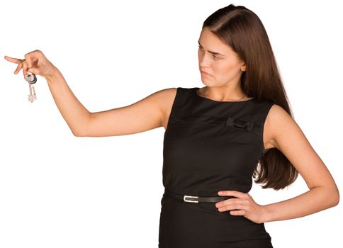 Businesswoman in dress holding house key. Isolated on white background