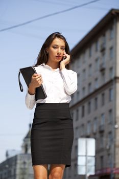 Young beautiful business woman talking on mobile phone