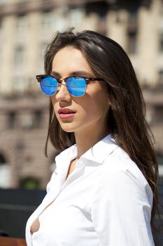 Young beautiful business woman with blue mirrored sunglasses