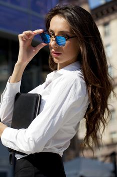 Young beautiful business woman with blue mirrored sunglasses