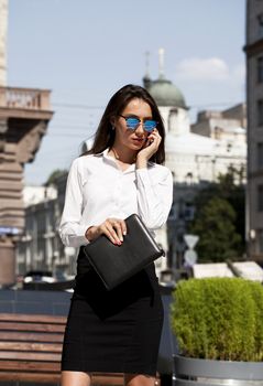 Young beautiful business woman talking on mobile phone