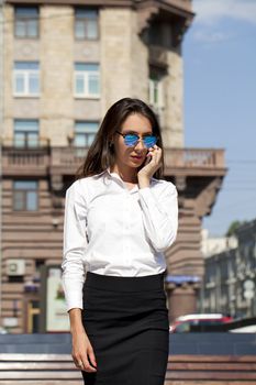 Young beautiful business woman talking on mobile phone