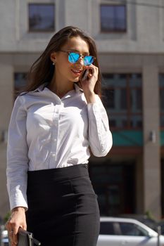 Young beautiful business woman talking on mobile phone