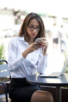 Portrait of young businesswoman working on a laptop