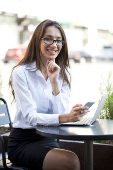 Portrait of young businesswoman working on a laptop