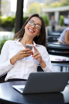 Portrait of young businesswoman working on a laptop