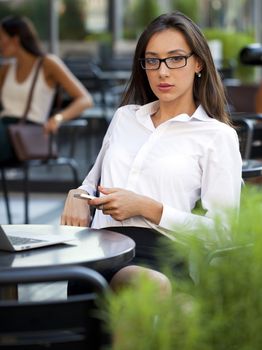 Portrait of young businesswoman working on a laptop