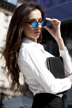 Young beautiful business woman with blue mirrored sunglasses