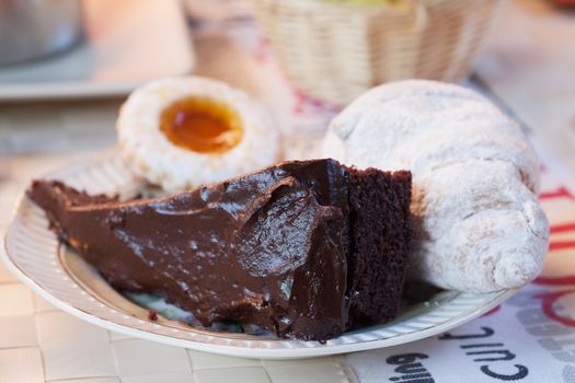 Cake, croissant and biscuit on a plate for breakfast