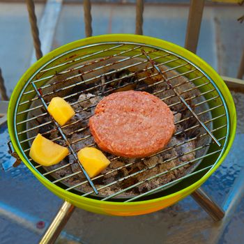 Hamburger and potatoes cooked on a barbecue