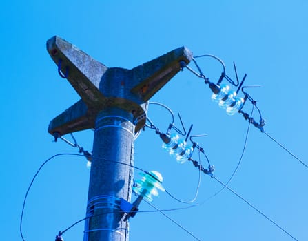 Top of electric pole in blue sky