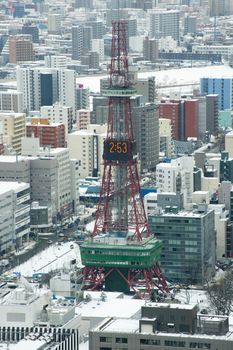 City of Sapporo, Japan in winter viewed from the JR Tower looking over the rooftops of the high rise buildings and skyscrapers showing the architecture of the CBD