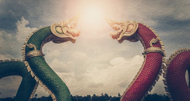 Vintage photo of Thai dragon or king of Na-ga statue, With sunshine on sky background.