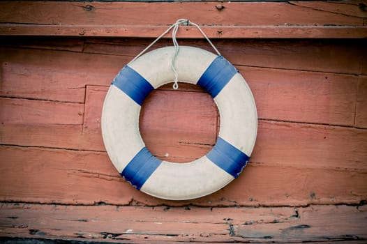 lifebuoy blue stripes. attached to side of the ship. readily available.