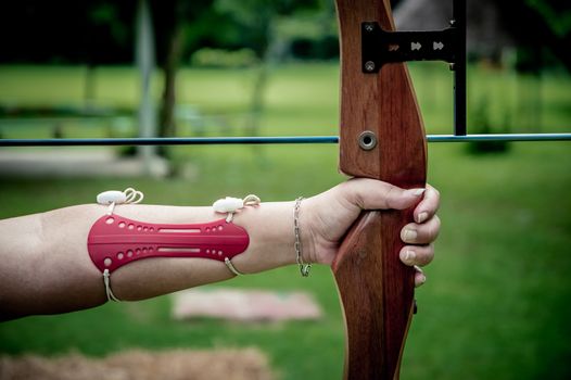 Young women  holds her bow aiming