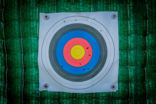 Close up of a shooting target and bullseye with bullet holes