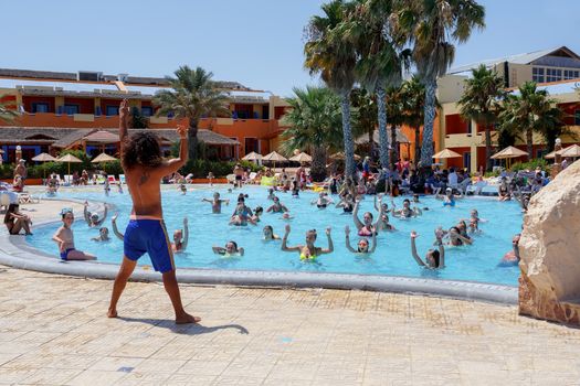BORJ CEDRIA, TUNISIA - AUGUST 7: Tourists on holiday in an expensive hotel Carribean World are doing water aerobics in pool August 7, 2014 Borj Cedria, Tunisia. 