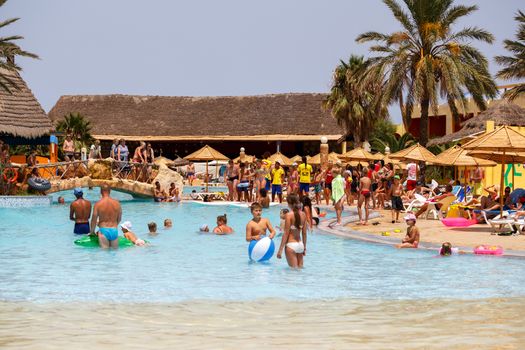 BORJ CEDRIA, TUNISIA - AUGUST 5: Tourists on holiday in an expensive hotel Carribean World in pool August 5, 2014 Borj Cedria, Tunisia. 