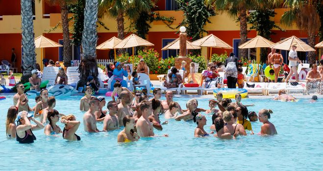 BORJ CEDRIA, TUNISIA - AUGUST 8: Tourists on holiday in an expensive hotel Carribean World are doing water aerobics in pool August 8, 2014 Borj Cedria, Tunisia. 