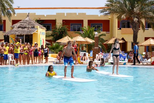 BORJ CEDRIA, TUNISIA - AUGUST 5: Tourists in animation competition program on holiday in an hotel Carribean World in pool August 5, 2014 Borj Cedria, Tunisia. 
