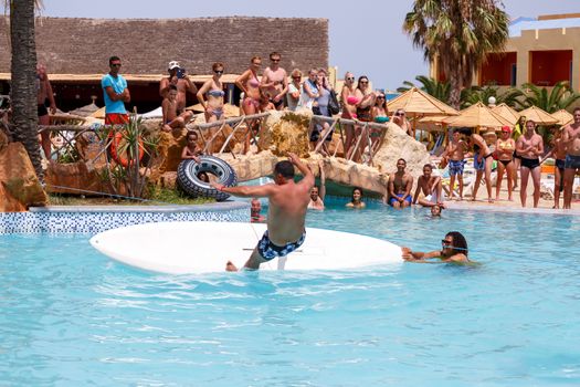 BORJ CEDRIA, TUNISIA - AUGUST 5: Tourists in animation competition program on holiday in an hotel Carribean World in pool August 5, 2014 Borj Cedria, Tunisia. 
