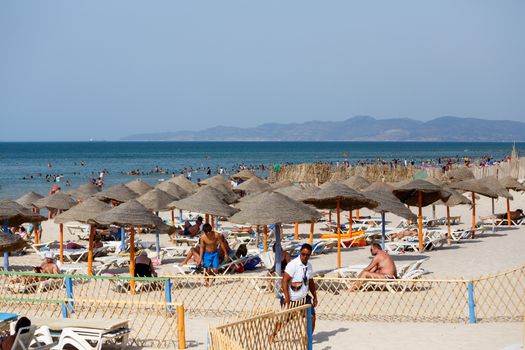 BORJ CEDRIA, TUNISIA - AUGUST 10: People relaxing at hotel beach. Club Caribbean also offers, large outdoor pool, excellent entertainment team and children�s club. August 10, 2014 Borj Cedria, Tunisia.