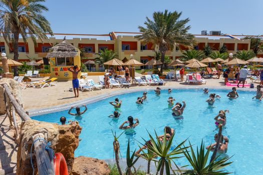 BORJ CEDRIA, TUNISIA - AUGUST 7: Tourists on holiday in an expensive hotel Carribean World are doing water aerobics in pool August 7, 2014 Borj Cedria, Tunisia. 