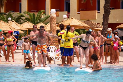 BORJ CEDRIA, TUNISIA - AUGUST 5: Tourists in animation competition program on holiday in an hotel Carribean World in pool August 5, 2014 Borj Cedria, Tunisia. 