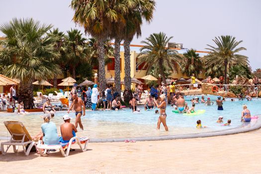BORJ CEDRIA, TUNISIA - AUGUST 5: Tourists on holiday in an expensive hotel Carribean World in pool August 5, 2014 Borj Cedria, Tunisia. 