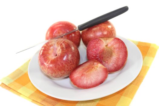 orange-red pluots on a light background