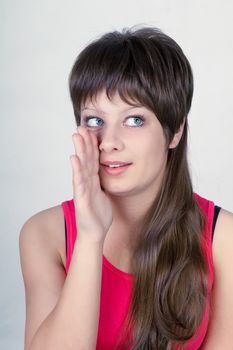 Smiling young girl speaks what is the secretly