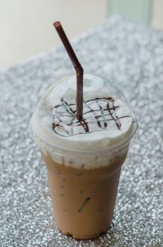 Iced coffee with straw in plastic cup for take aways