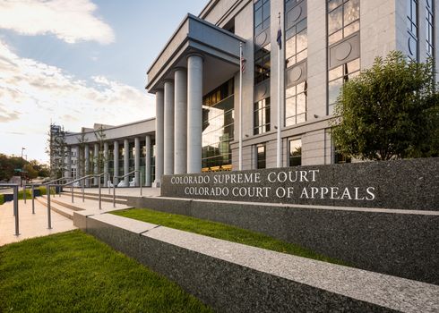 Sign and entrance steps to modern building housing the Colorado Supreme Court and Court of Appeals in Denver CO