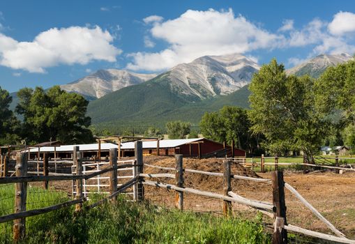 Farmyard and stables behind fencing with Mount Princeton near Buena Vista Colorado