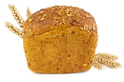 A loaf of bread with sunflower seeds, sesame seeds, grains of wheat and spikelets of wheat on a white background