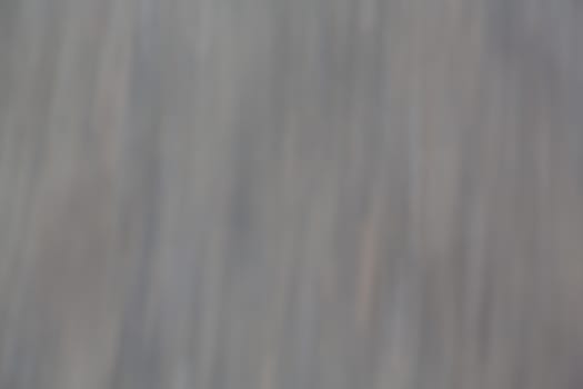 Defocused and slight element on motion blur on grey and hint of color background that has dreamy dreamlike calm feeling