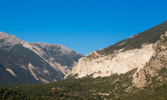 Valley of  chalk white cliffs of Mount Princeton near Buena Vista in Colorado shortly after sunrise as the sun first lights the mountainside