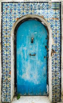 Blue aged door with ornament and tiles from Sidi Bou Said in Tunisia. Large resolution