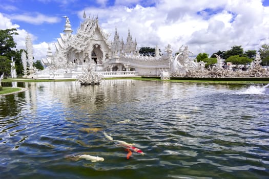 Fountain, Fishes, White Temple. Contemporary unconventional Buddhist temple in Chiang Rai