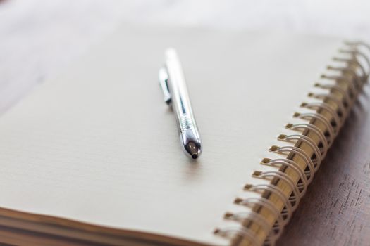 Closeup spiral notebook and pen, stock photo