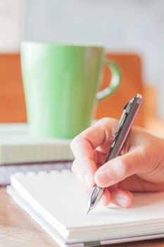 Hand writing with green mug background, stock photo