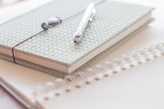 Closeup pen and green covered notebook, stock photo