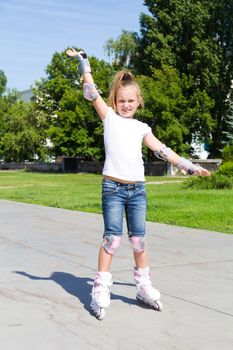 Photo of cute girl on roller skates in summer