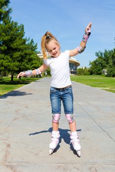 Photo of cute girl on roller skates in summer