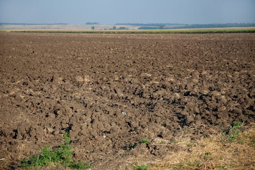 Landscape with sky and brown tilled soil