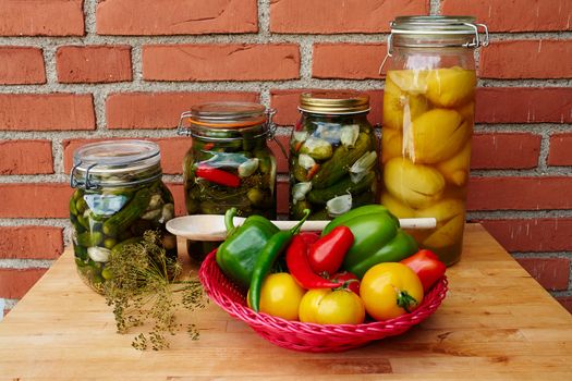Fresh homemade pickles cucumbers and lemons in glass gars                               
