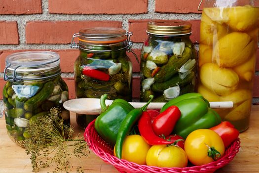 Fresh homemade pickles cucumbers and lemons in glass gars