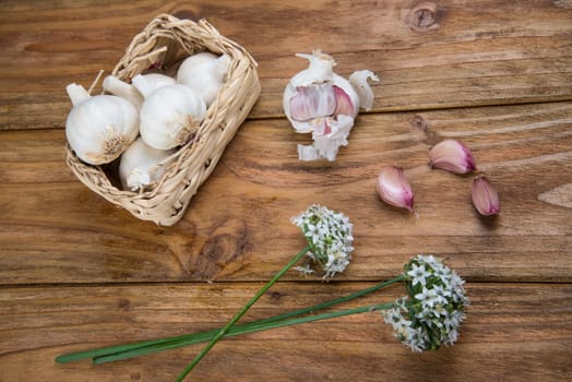 Fresh garlic bulb and flowers and naan bread on kitchen table