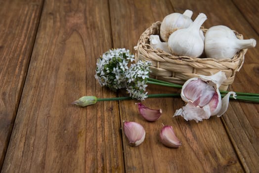 Fresh garlic bulb and flowers and naan bread on kitchen table